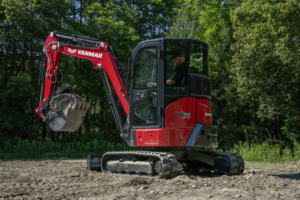 A Yanmar ViO35-7 mini excavator sits on a field