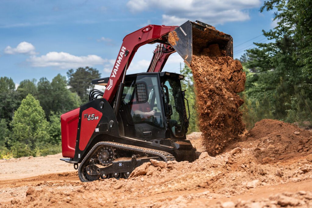 A Yanmar TL65RS Compact Track Loader dumps dirt from its raised bucket