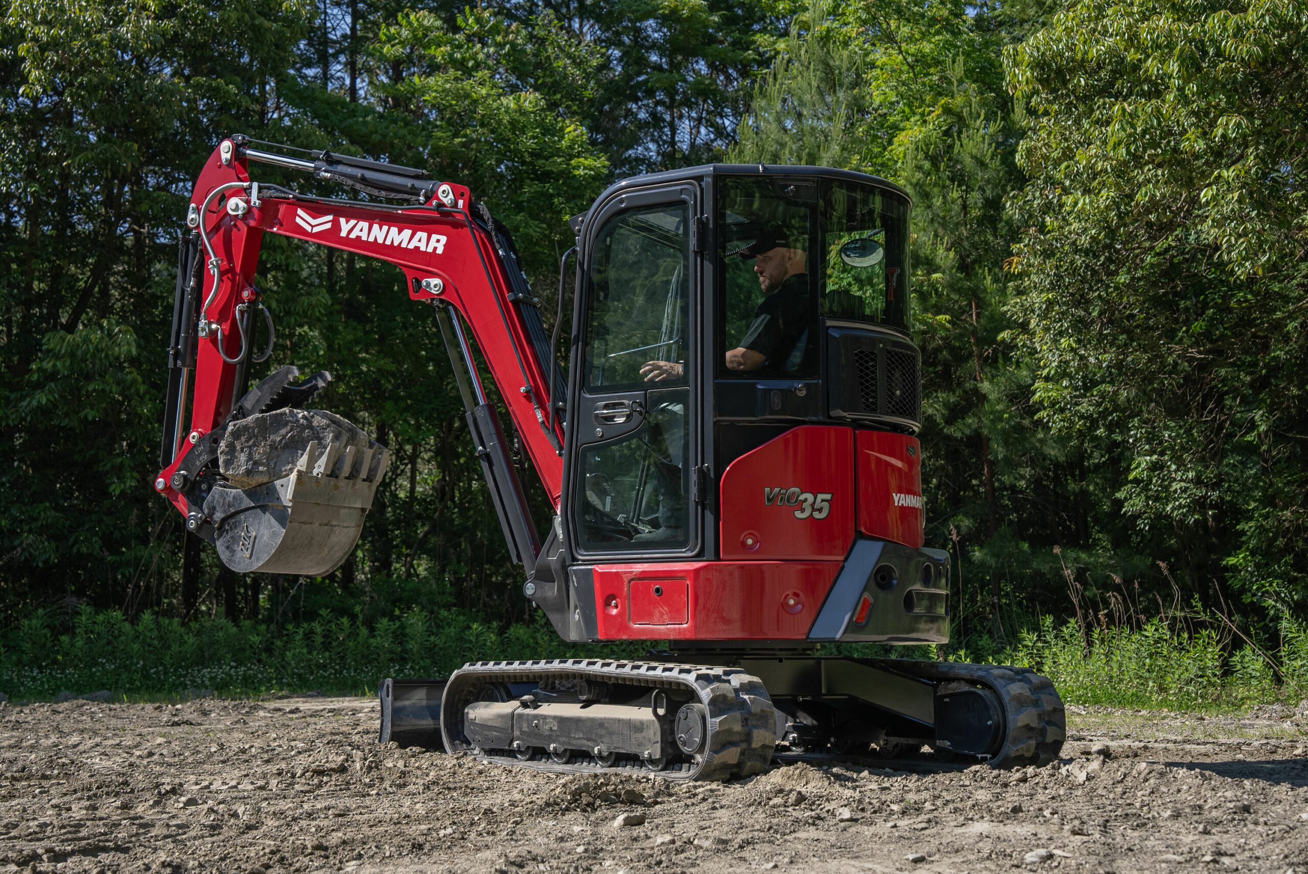 Yanmar ViO35-7 Mini Excavator in Action with Full Bucket of Dirt - Powerful 24.4 HP Excavator Demonstrating Efficient Earthmoving and Digging Performance