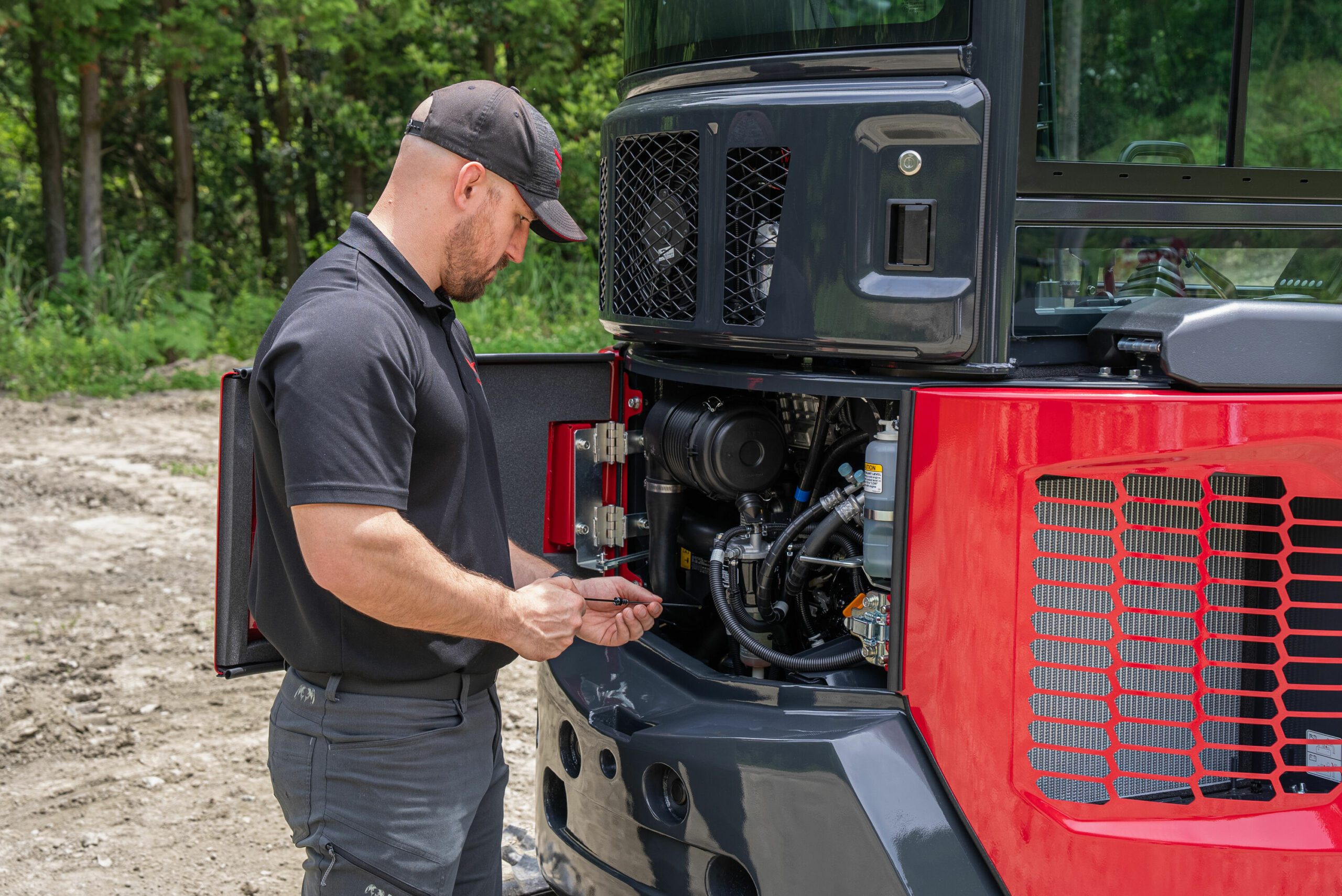 Operator Easily Servicing Yanmar ViO35-7 Mini Excavator in the Field - Simple Maintenance and Quick Access for Increased Uptime and Efficiency