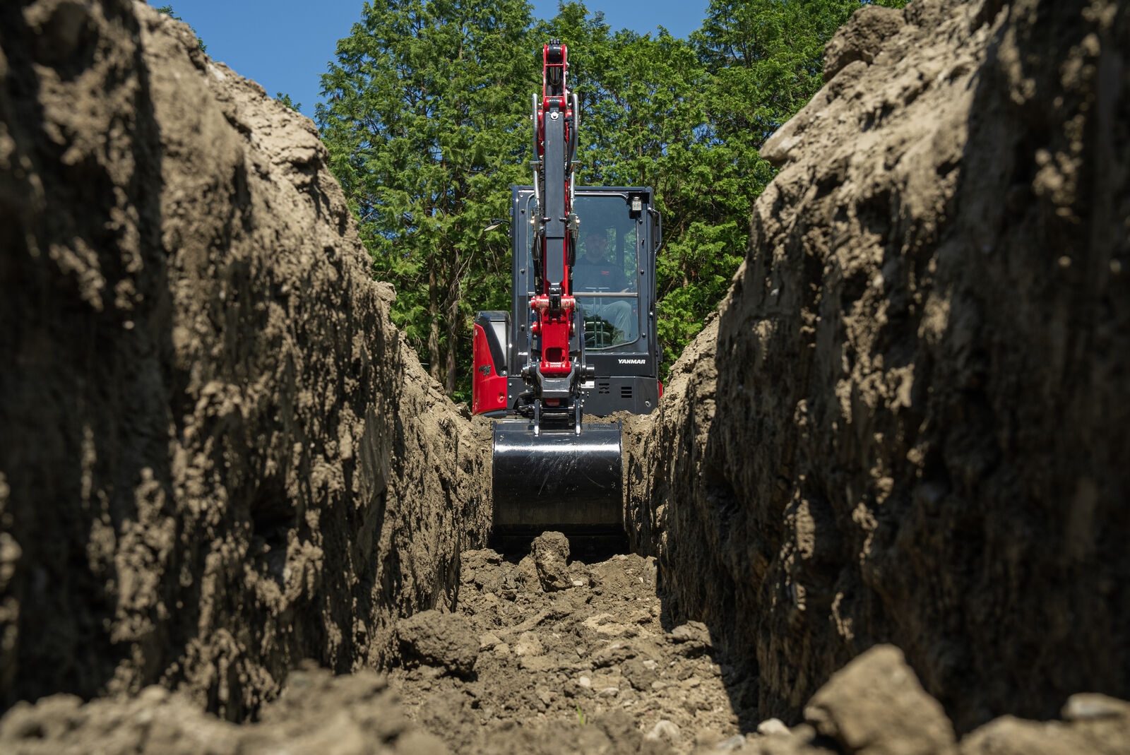 Front view of Yanmar ViO35-7 mini excavator in a trench after digging with zero tail swing.