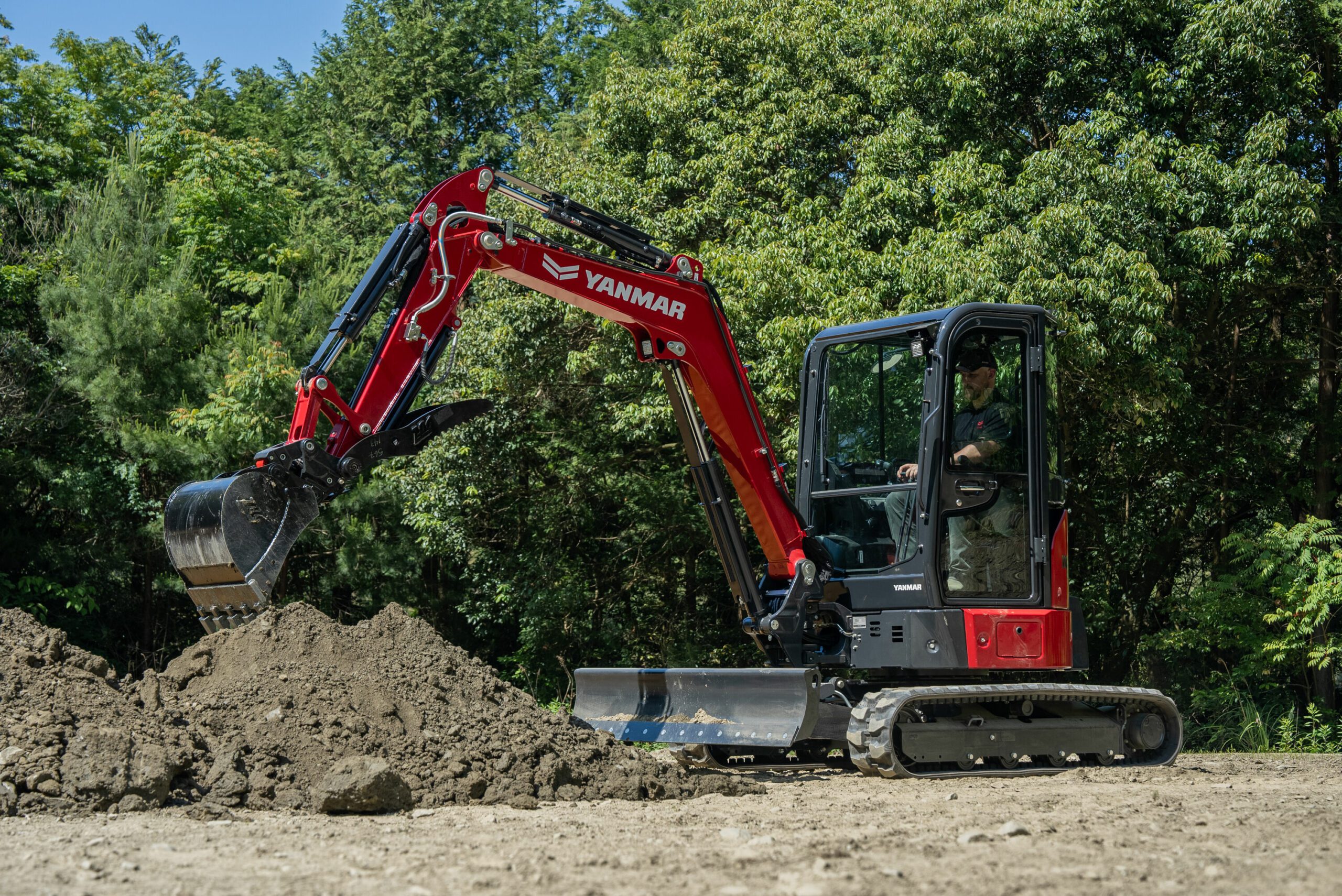 Yanmar ViO35-7 Mini Excavator Working in Front of Dirt Pile - Powerful 24.4 HP Excavator Demonstrating Efficient Earthmoving and Digging Performance on Construction Site