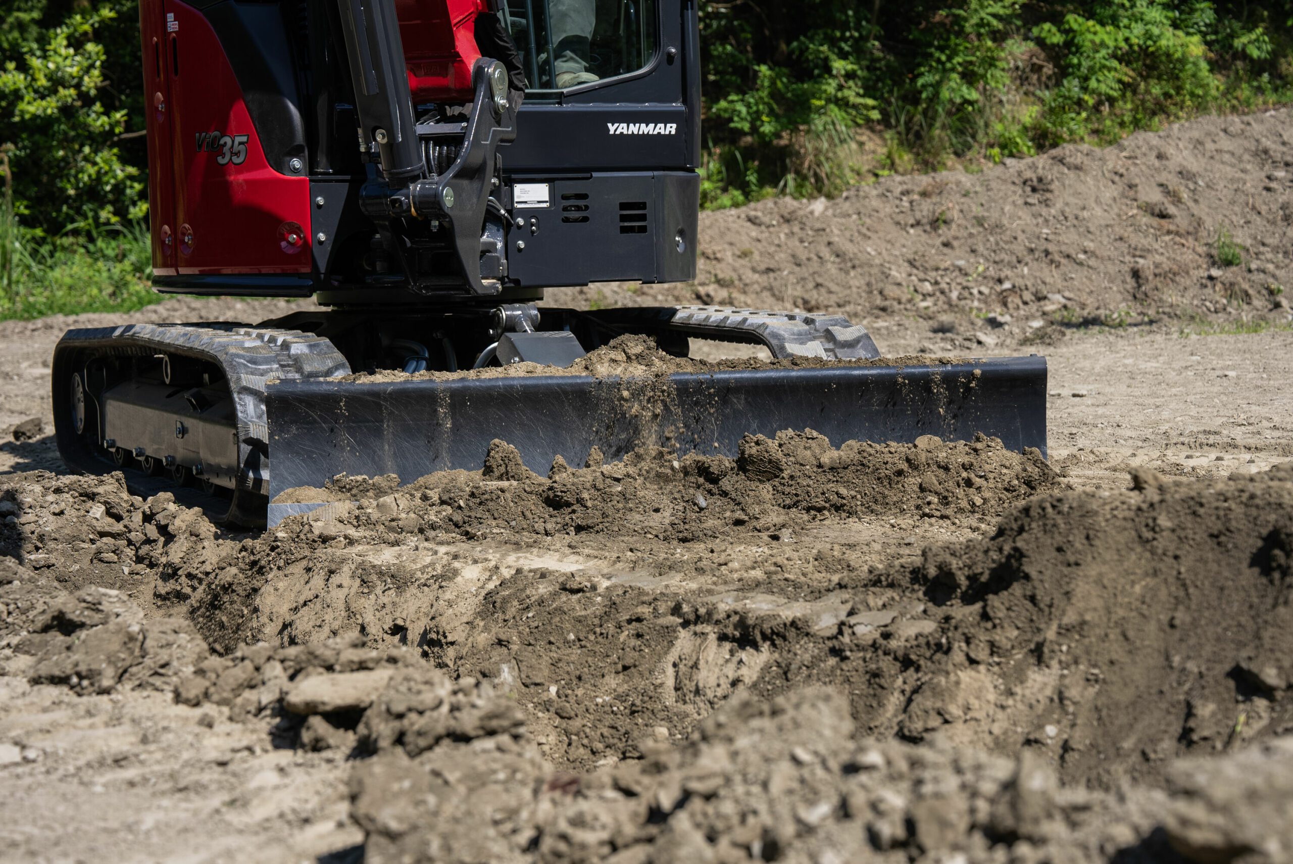 Yanmar ViO35-7 Mini Excavator Using Dozer Blade to Push Dirt in the Field - Efficient Earthmoving and Grading with Compact 24.4 HP Excavator