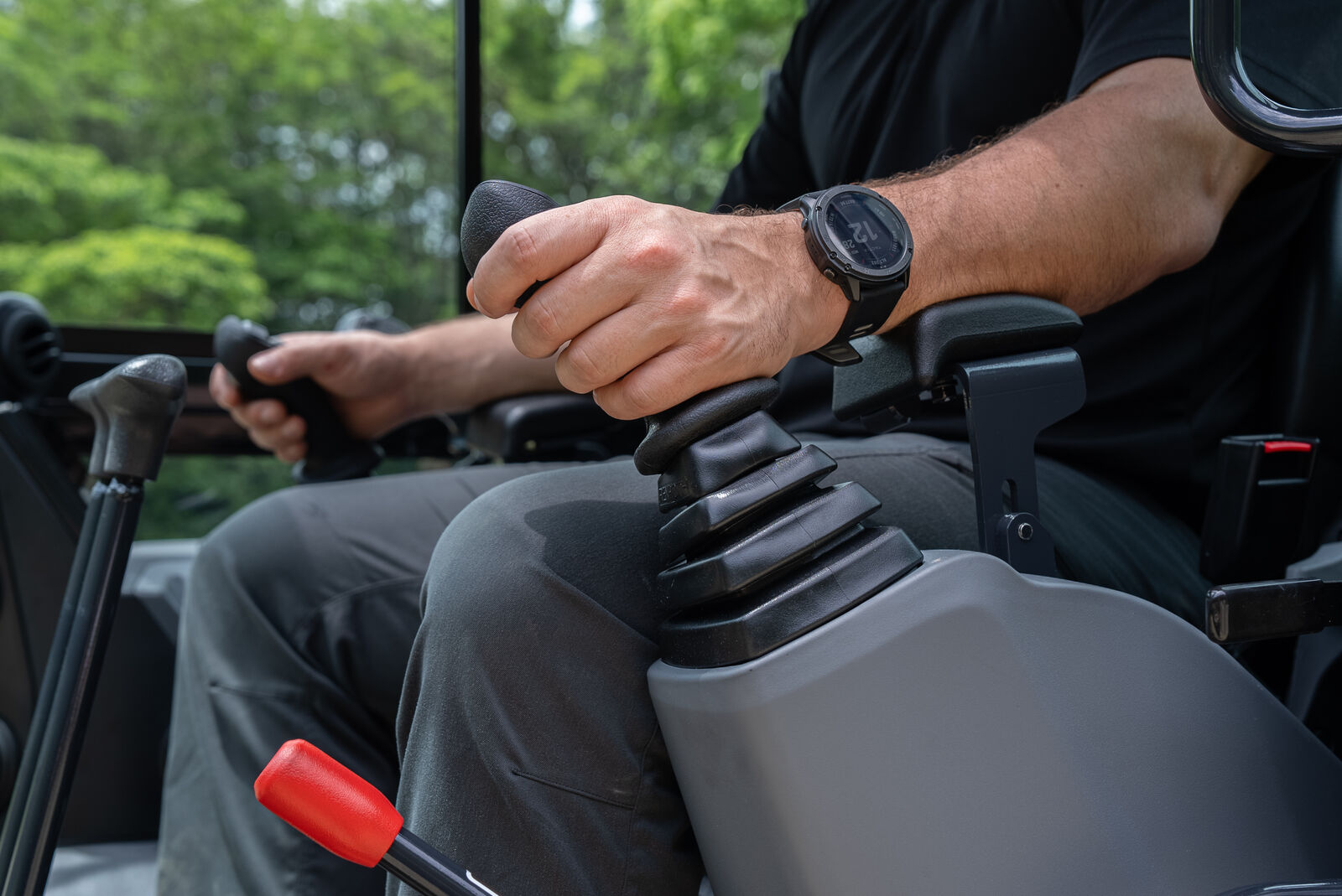 Operator using joystick controls in Yanmar ViO35-7 mini excavator for precise equipment maneuvering.