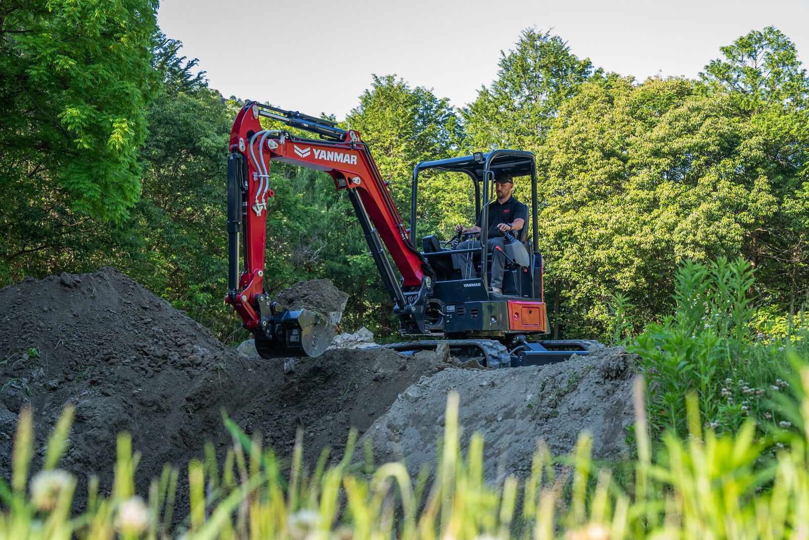 Wide shot of Yanmar ViO35-7 mini excavator digging on a job site with powerful performance.